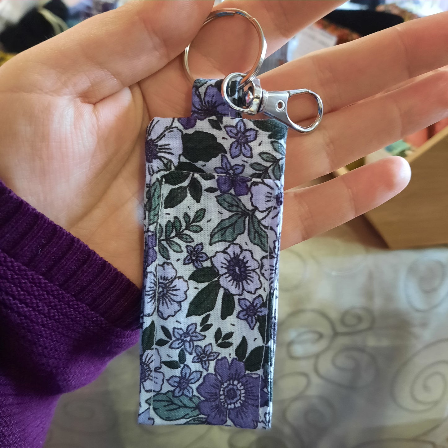 Porte-clé pour baume à lèvres en coton et fleurs mauves – accessoire beauté nomade élégant accroché à un sac à main